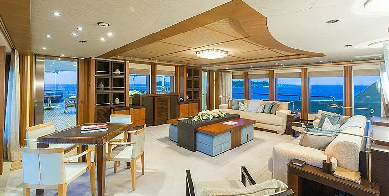 a living room with a couch and a table aboard WHEELS Yacht for Sale