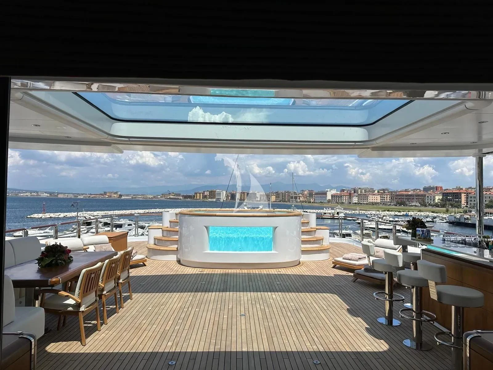 a room with tables and chairs aboard WHEELS Yacht for Sale