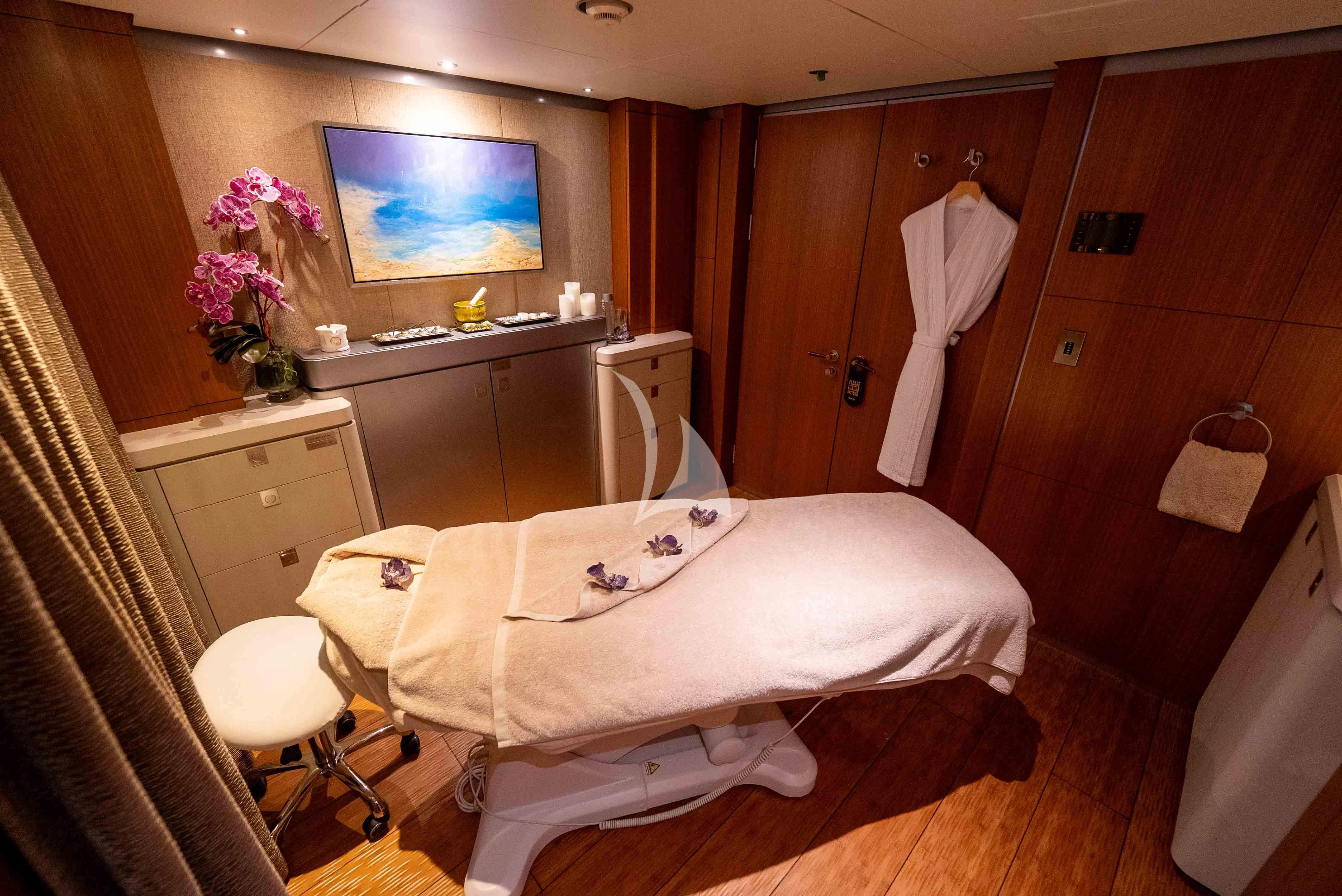 a room with a bed and a dresser aboard WHEELS Yacht for Sale
