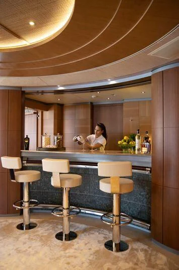a person sitting at a bar aboard WHEELS Yacht for Sale