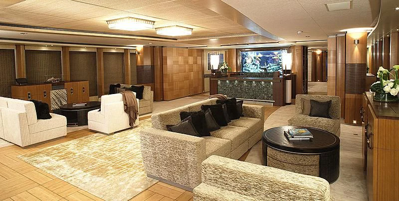 a large living room with a fireplace aboard WHEELS Yacht for Sale