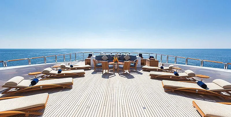 a deck with lounge chairs and a large body of water aboard WHEELS Yacht for Sale