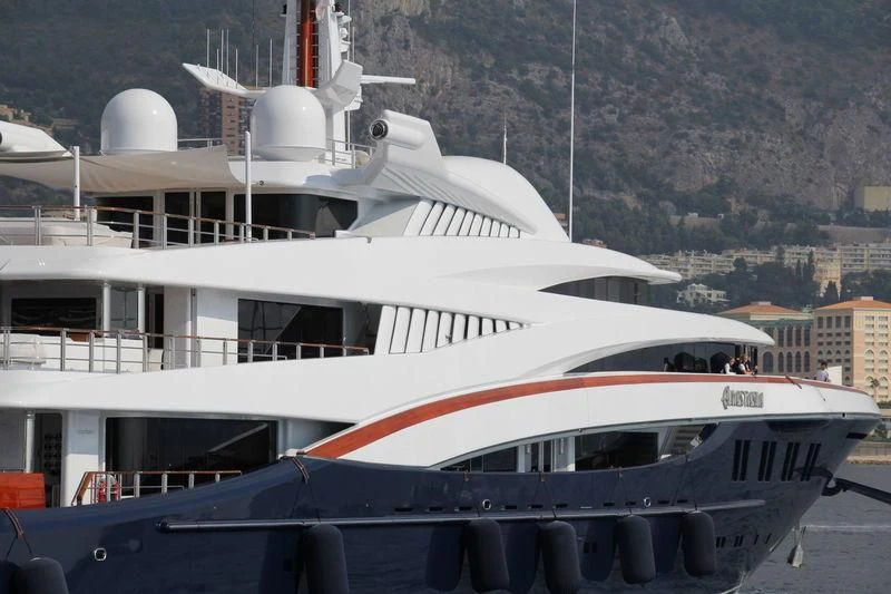 a boat docked in a harbor aboard WHEELS Yacht for Sale