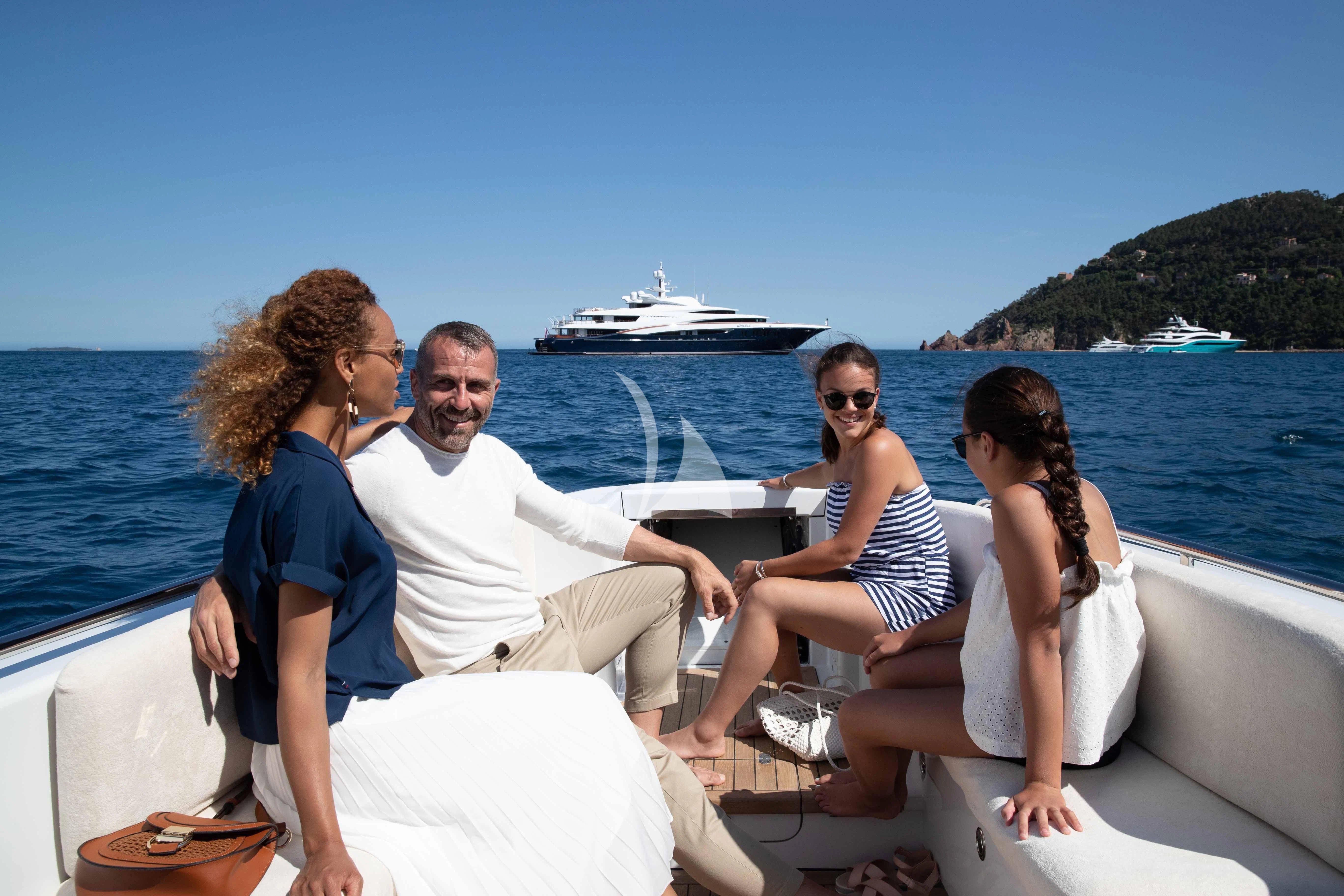 a group of people sitting on a boat aboard WHEELS Yacht for Sale