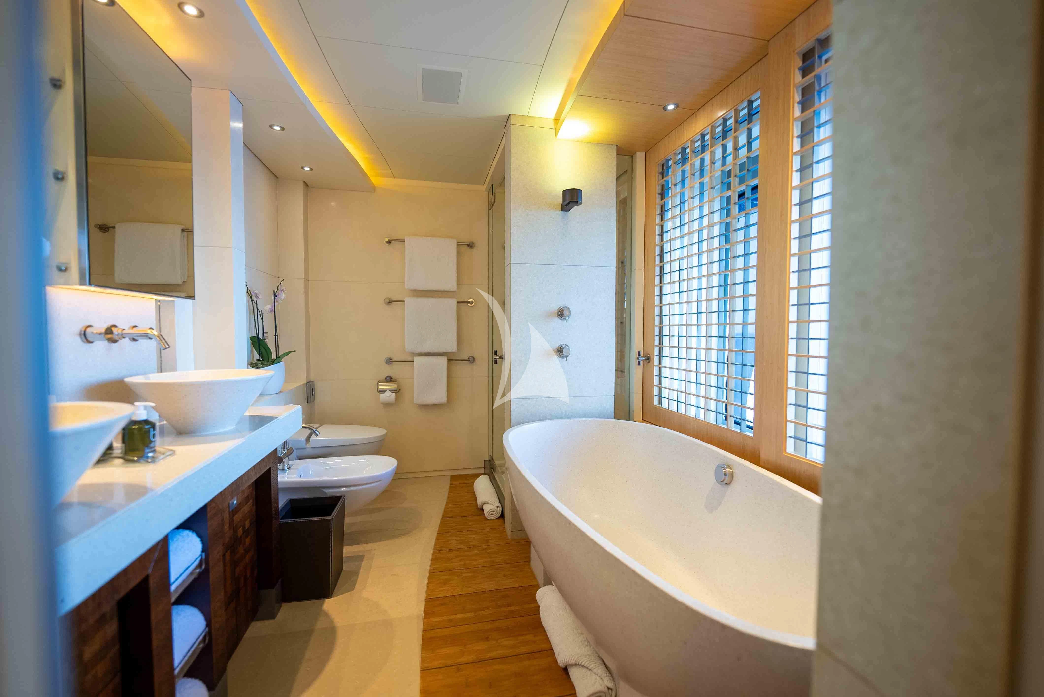 a bathroom with a tub sink and toilet aboard WHEELS Yacht for Sale
