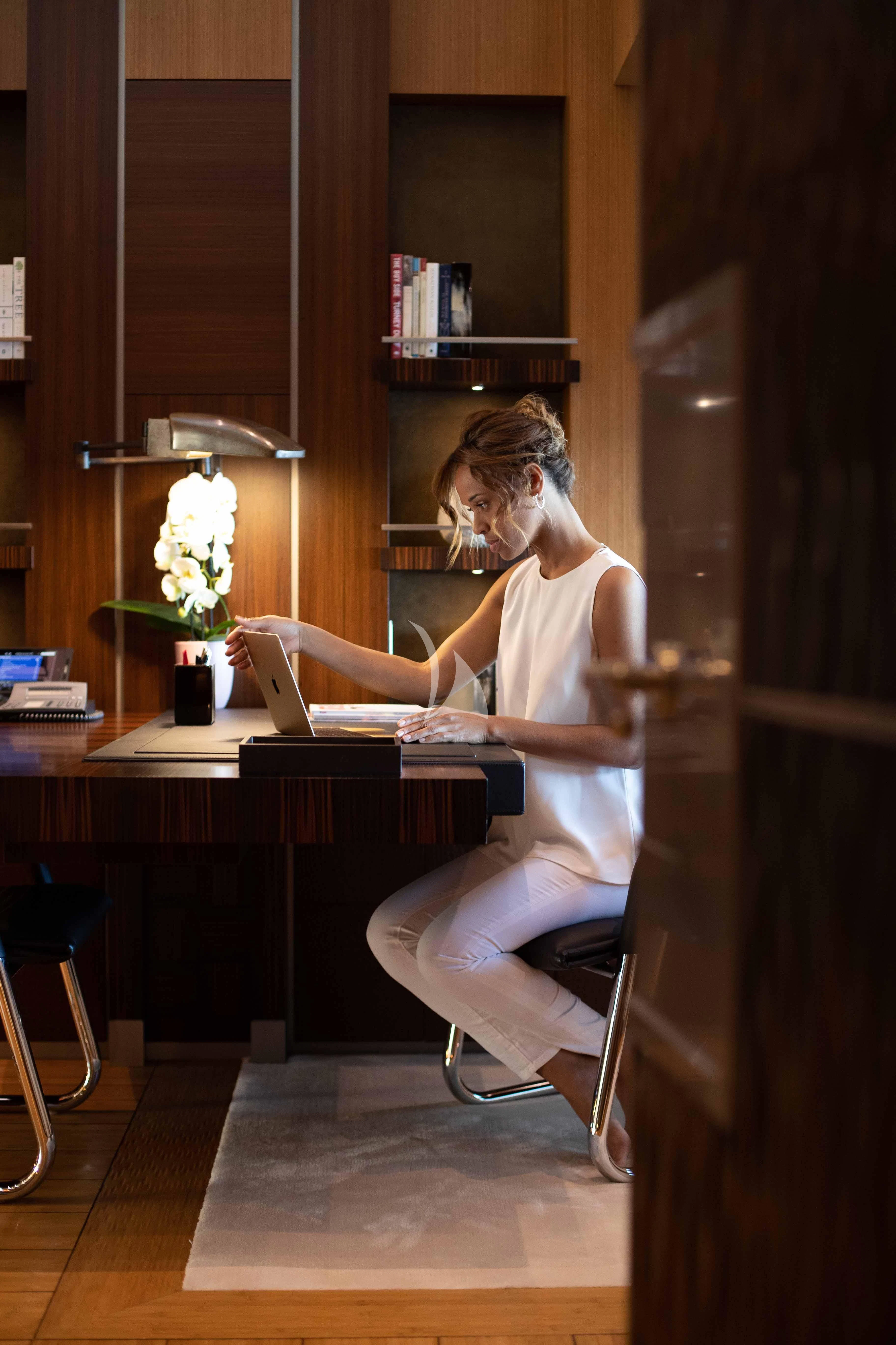 a person sitting at a desk aboard WHEELS Yacht for Sale