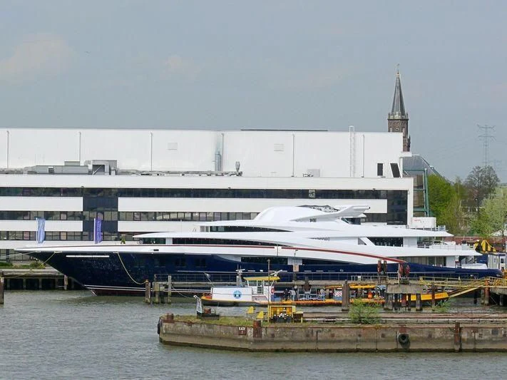 a large white boat docked aboard WHEELS Yacht for Sale