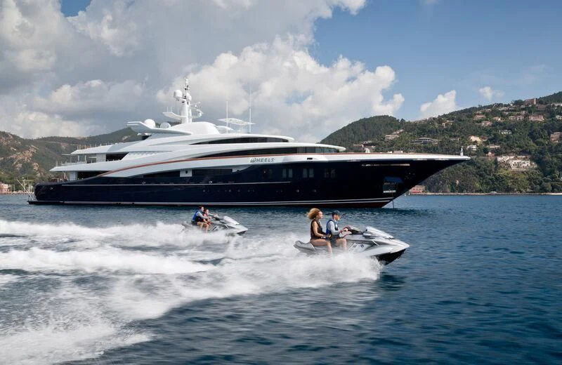 a boat with a boat in the water aboard WHEELS Yacht for Sale