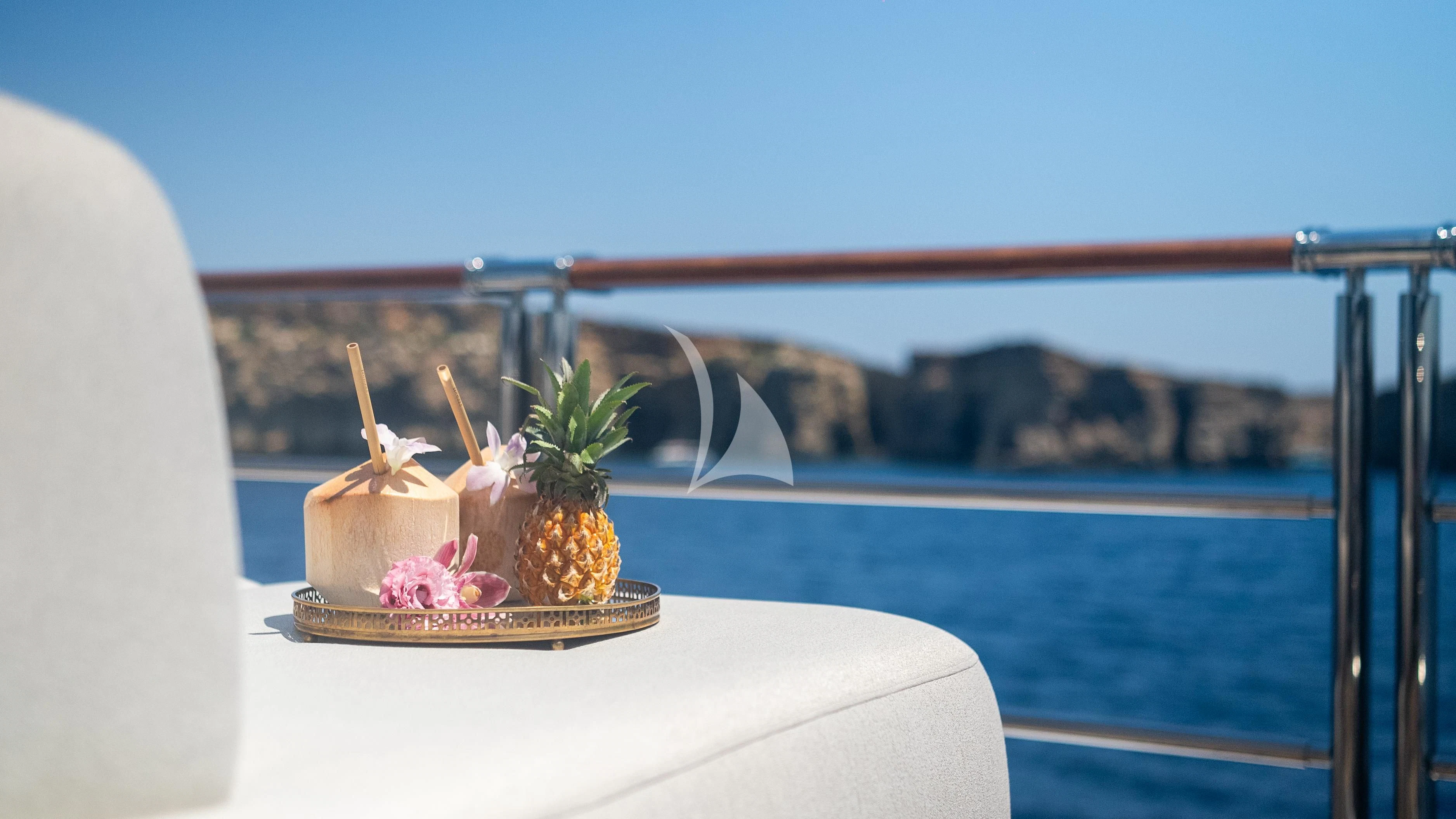 a table with a plant and a vase with flowers on it aboard WHEELS Yacht for Sale