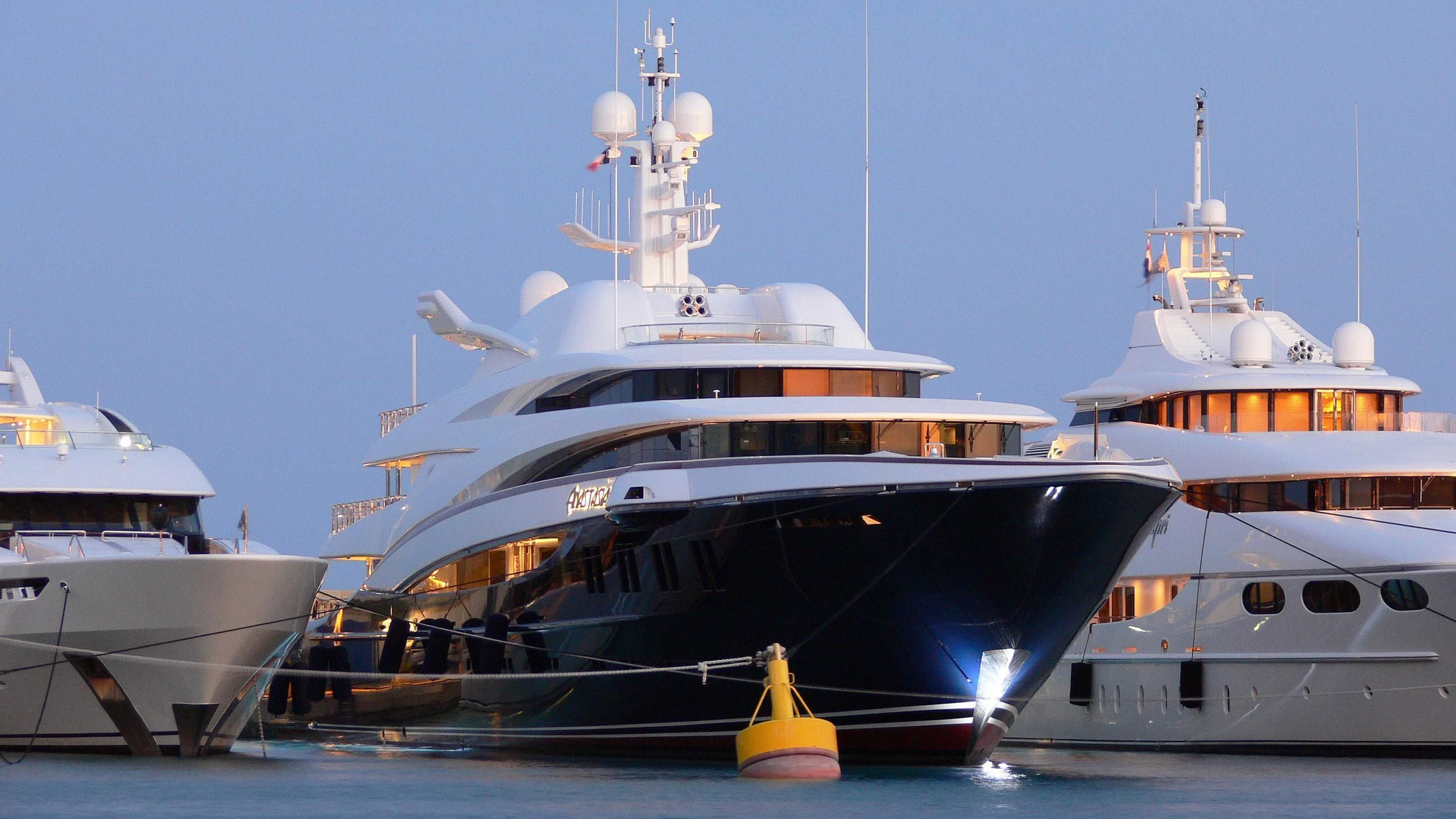 a group of boats in a harbor aboard WHEELS Yacht for Sale