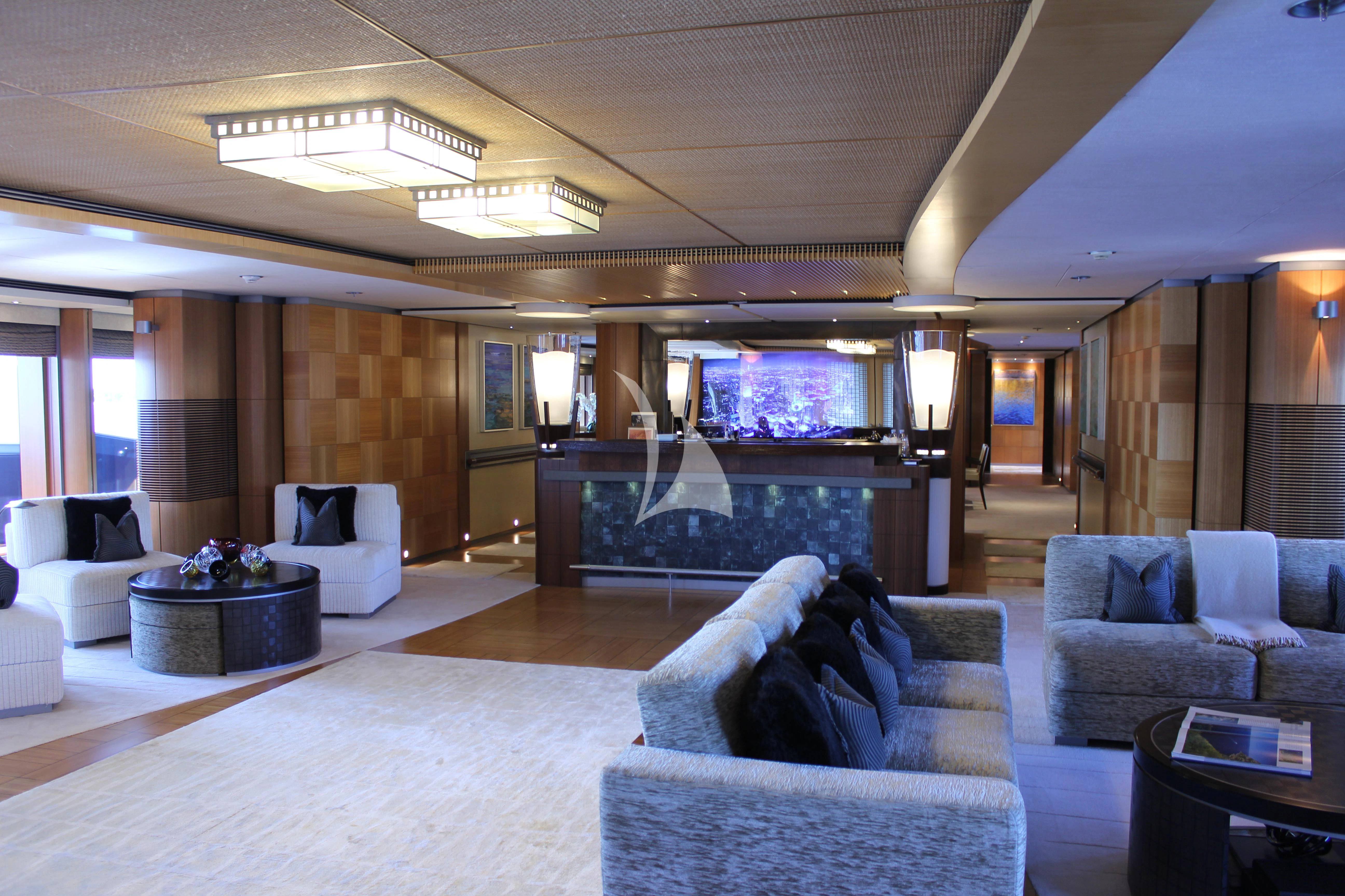 a living room with a large screen aboard WHEELS Yacht for Sale