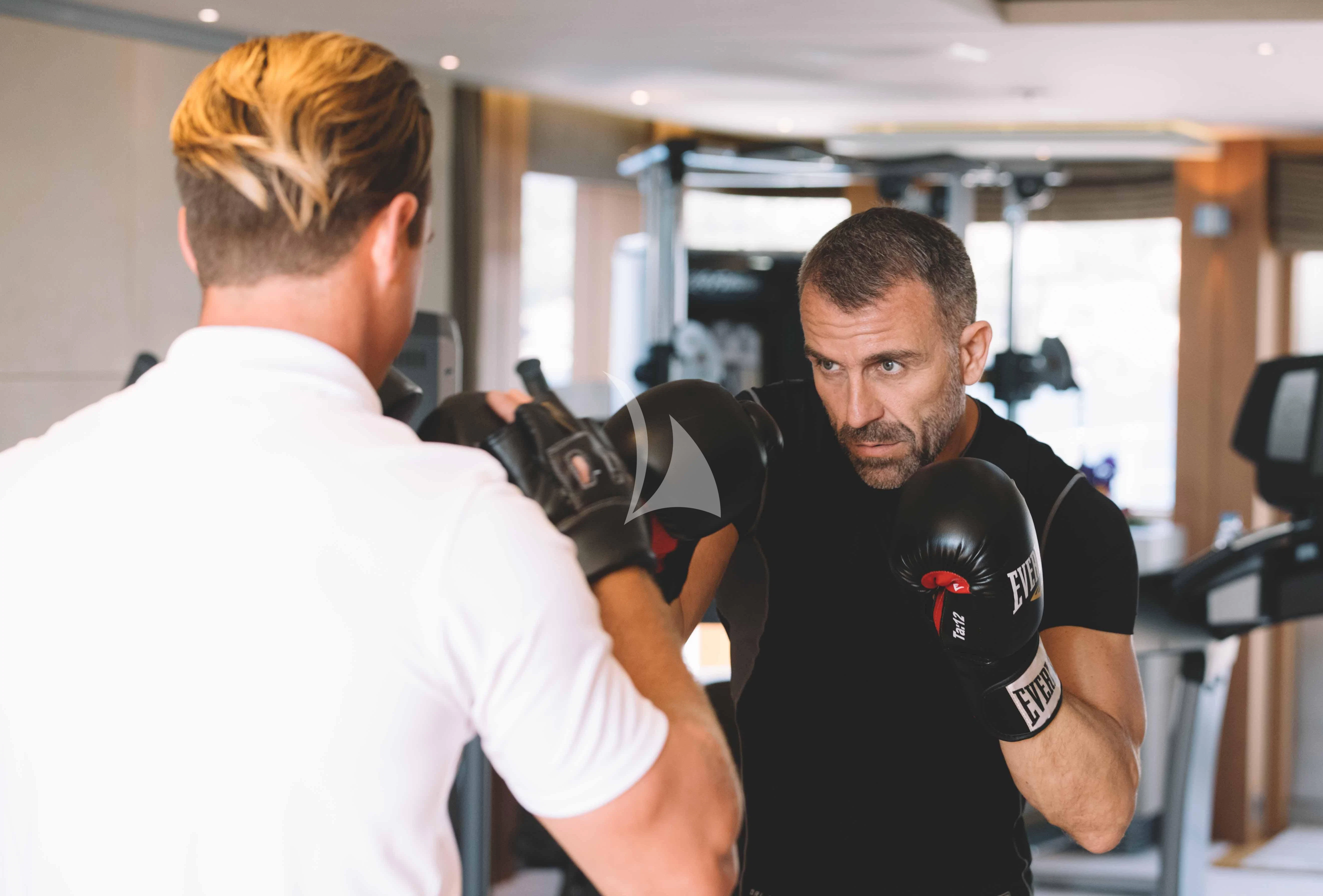 a man in a white shirt aboard WHEELS Yacht for Sale