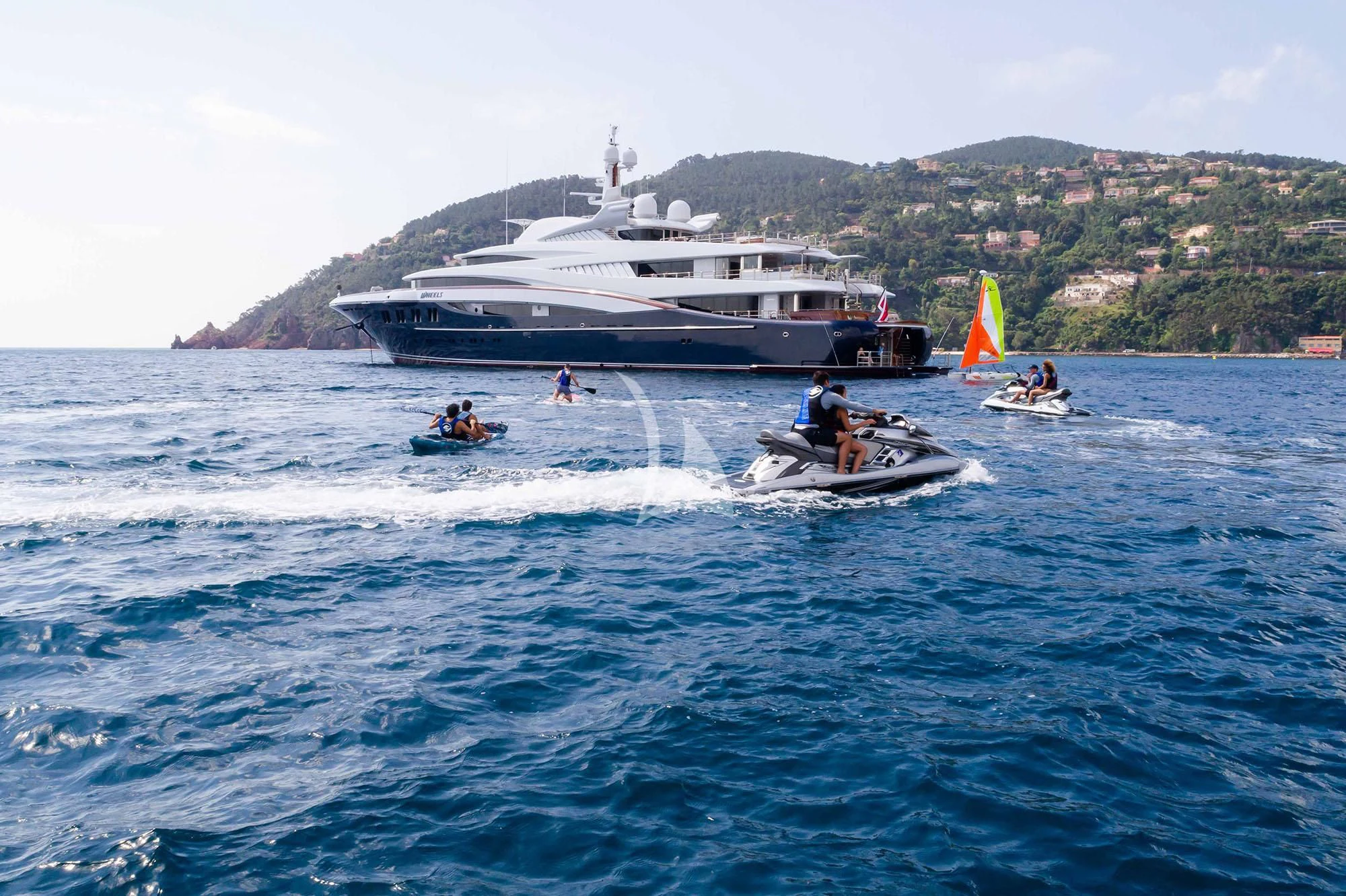 a boat sailing on the water aboard WHEELS Yacht for Sale