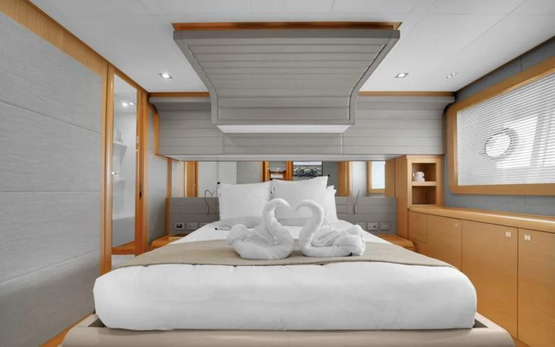 a room with a bed and a window aboard BON BON Yacht for Sale