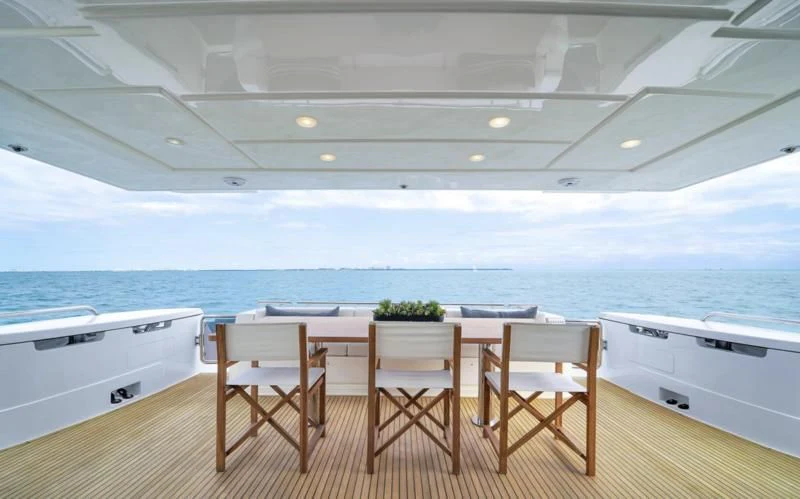 a table and chairs on a deck aboard BON BON Yacht for Sale