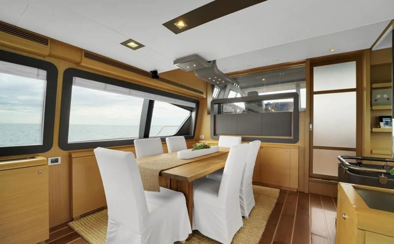 a room with a table and chairs aboard BON BON Yacht for Sale