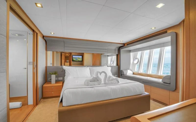 a room with a bed and a window aboard BON BON Yacht for Sale