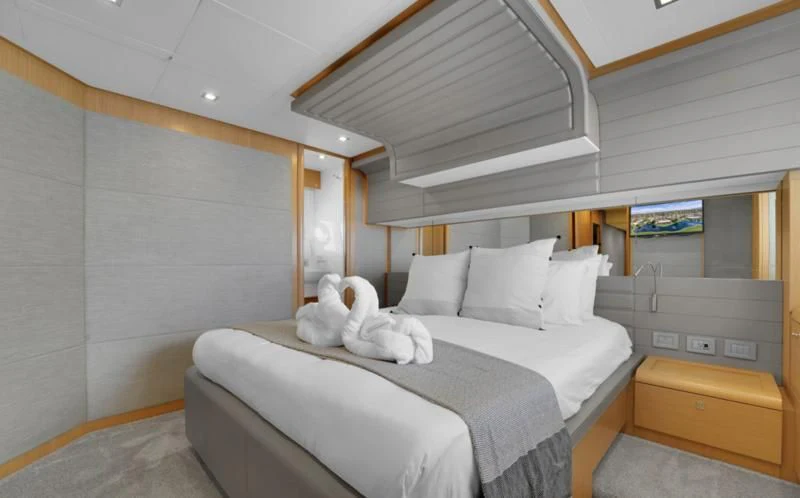 a white dog on a bed aboard BON BON Yacht for Sale