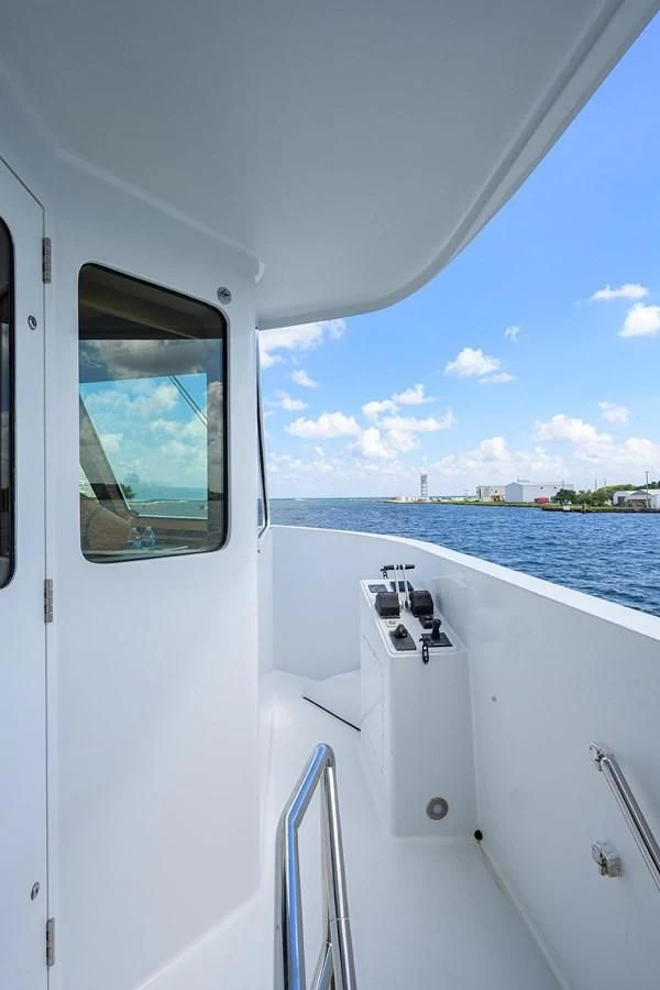 a boat with a view of the water and land below aboard OUR WAY Yacht for Sale