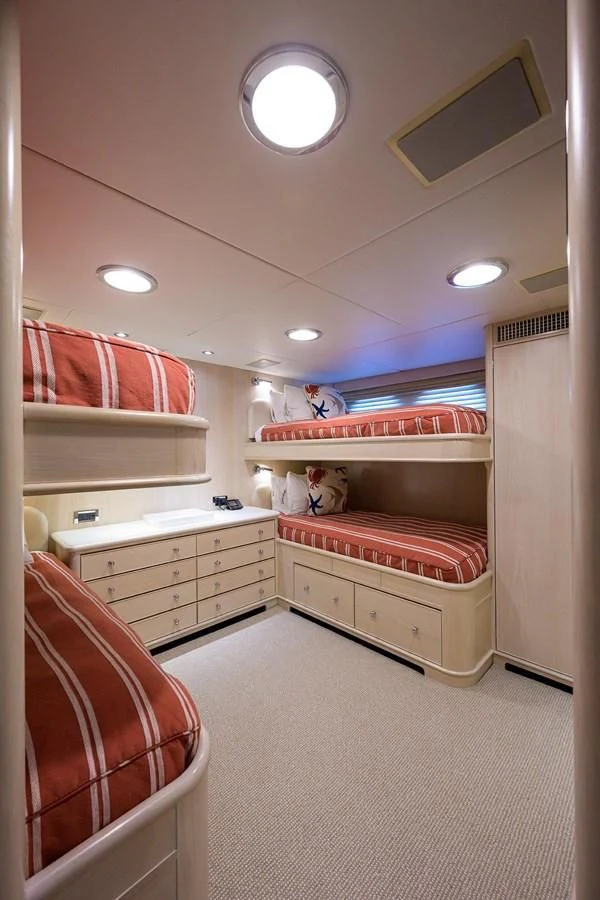 a room with a bed and a chair aboard OUR WAY Yacht for Sale
