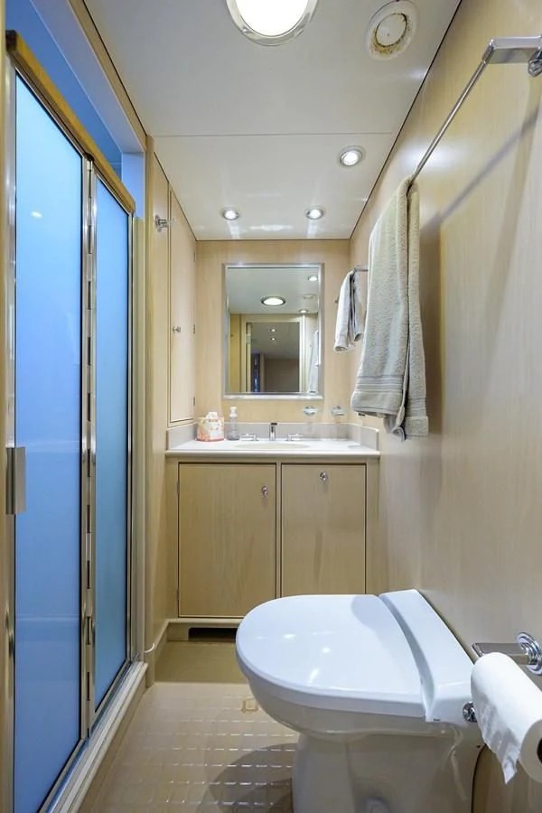 a bathroom with a blue shower door aboard OUR WAY Yacht for Sale