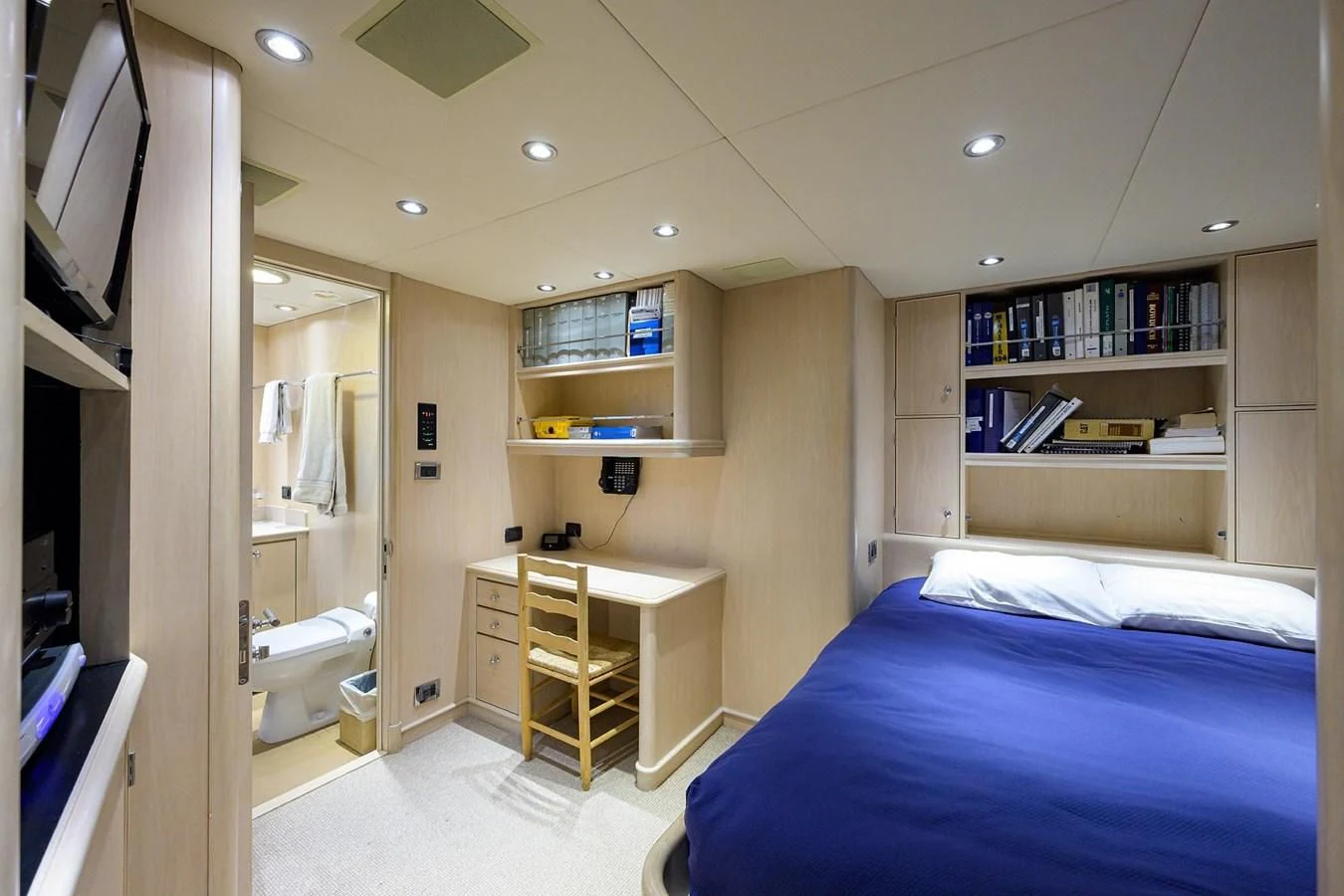 a bedroom with a bed and a desk aboard OUR WAY Yacht for Sale