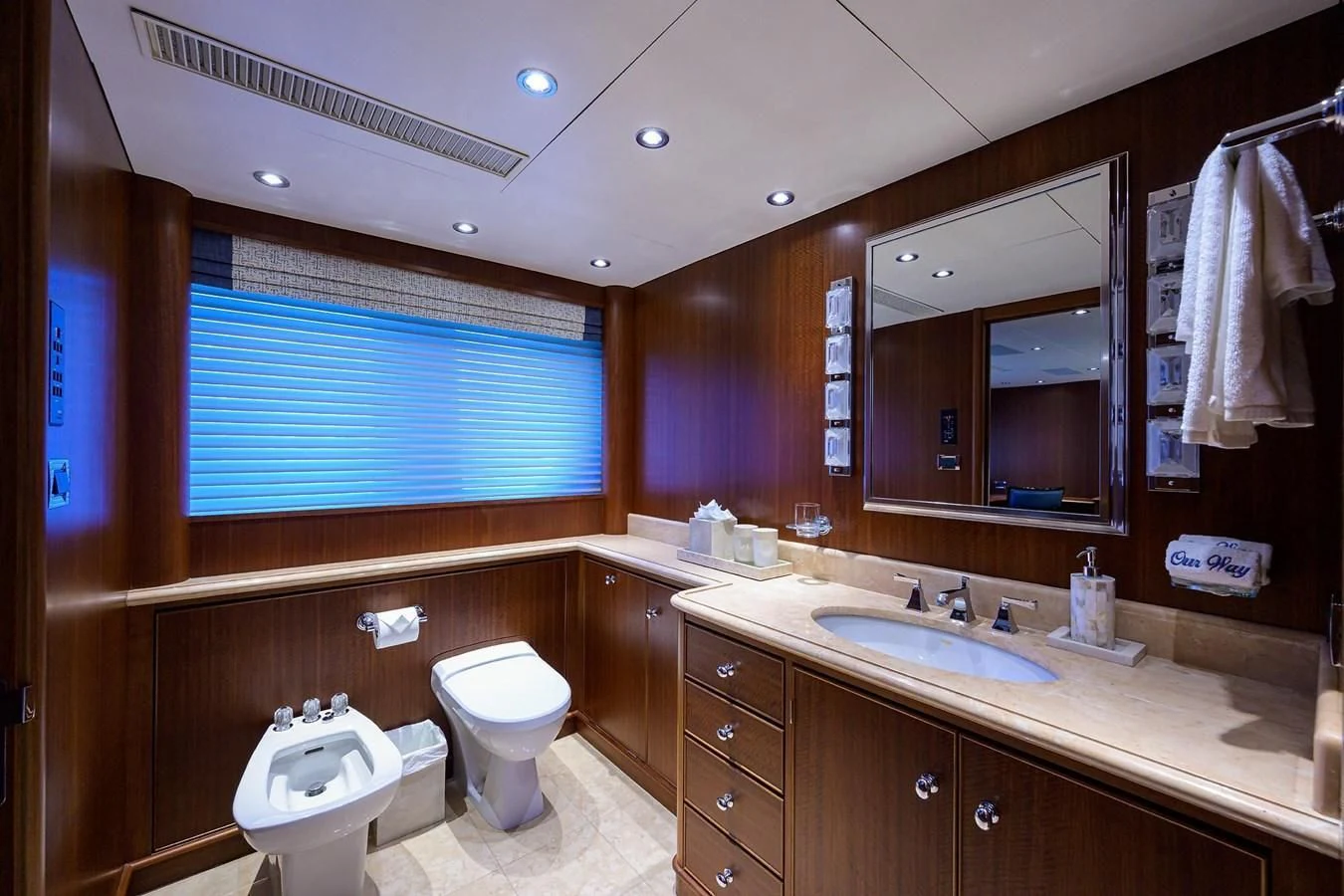 a bathroom with a sink toilet and a mirror aboard OUR WAY Yacht for Sale