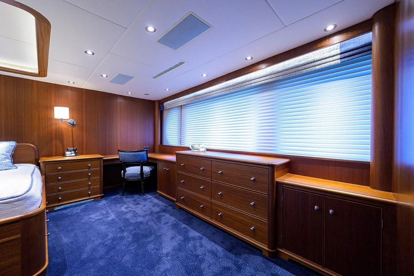 a bedroom with a bed and a desk aboard OUR WAY Yacht for Sale