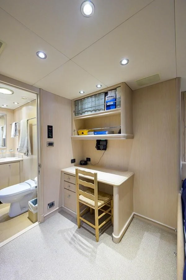 a bathroom with a desk and a shelf with books on it aboard OUR WAY Yacht for Sale