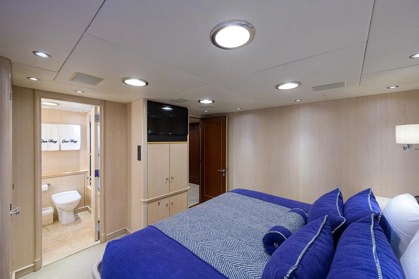 a bedroom with a blue bed aboard OUR WAY Yacht for Sale