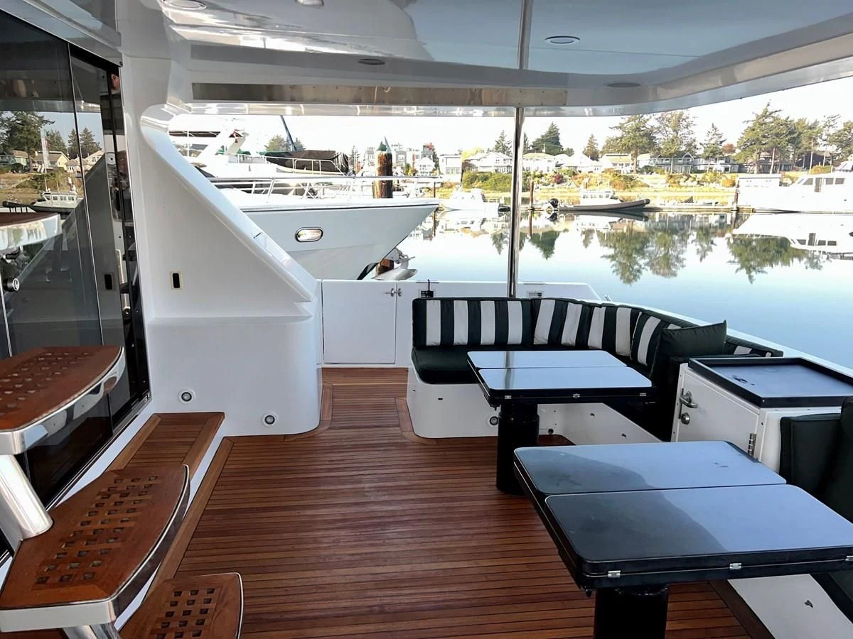 a room with a table and chairs aboard OREGON MIST Yacht for Sale