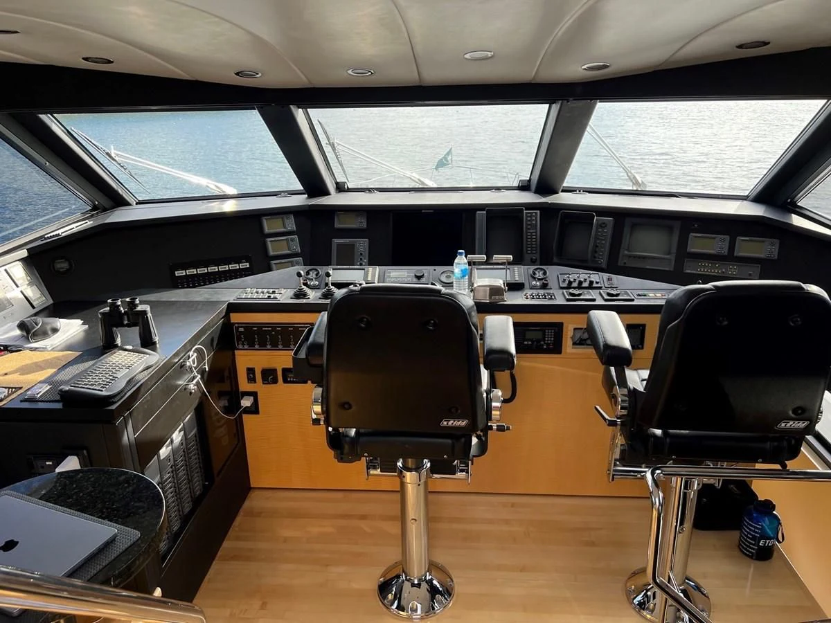 a large black and white piano in a room with a large window aboard OREGON MIST Yacht for Sale