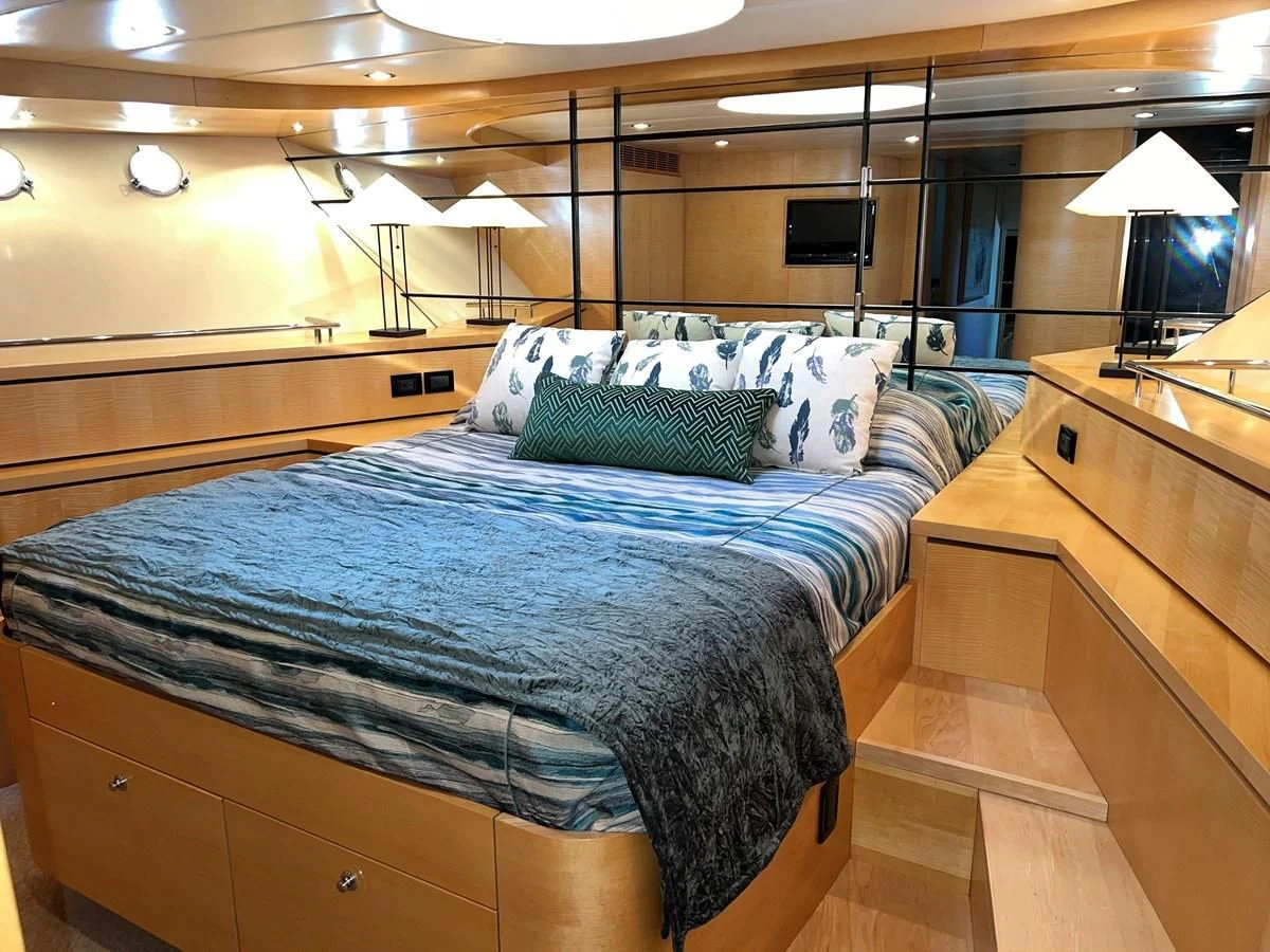 a bed with blue sheets aboard OREGON MIST Yacht for Sale