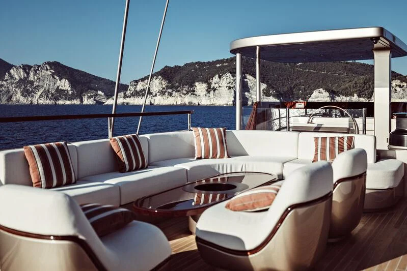 a table and chairs on a deck aboard ARTEXPLORER Yacht for Sale