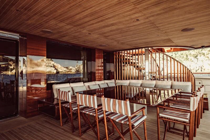 a room with tables and chairs aboard ARTEXPLORER Yacht for Sale