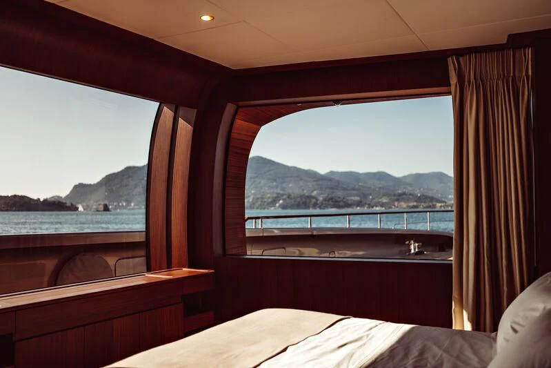 a room with a view of the ocean and mountains aboard ARTEXPLORER Yacht for Sale