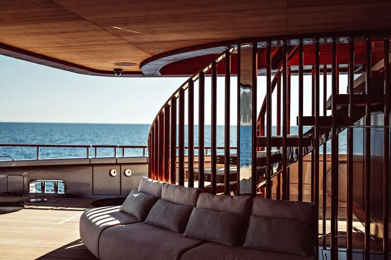 a couch in front of a large window overlooking the ocean aboard ARTEXPLORER Yacht for Sale