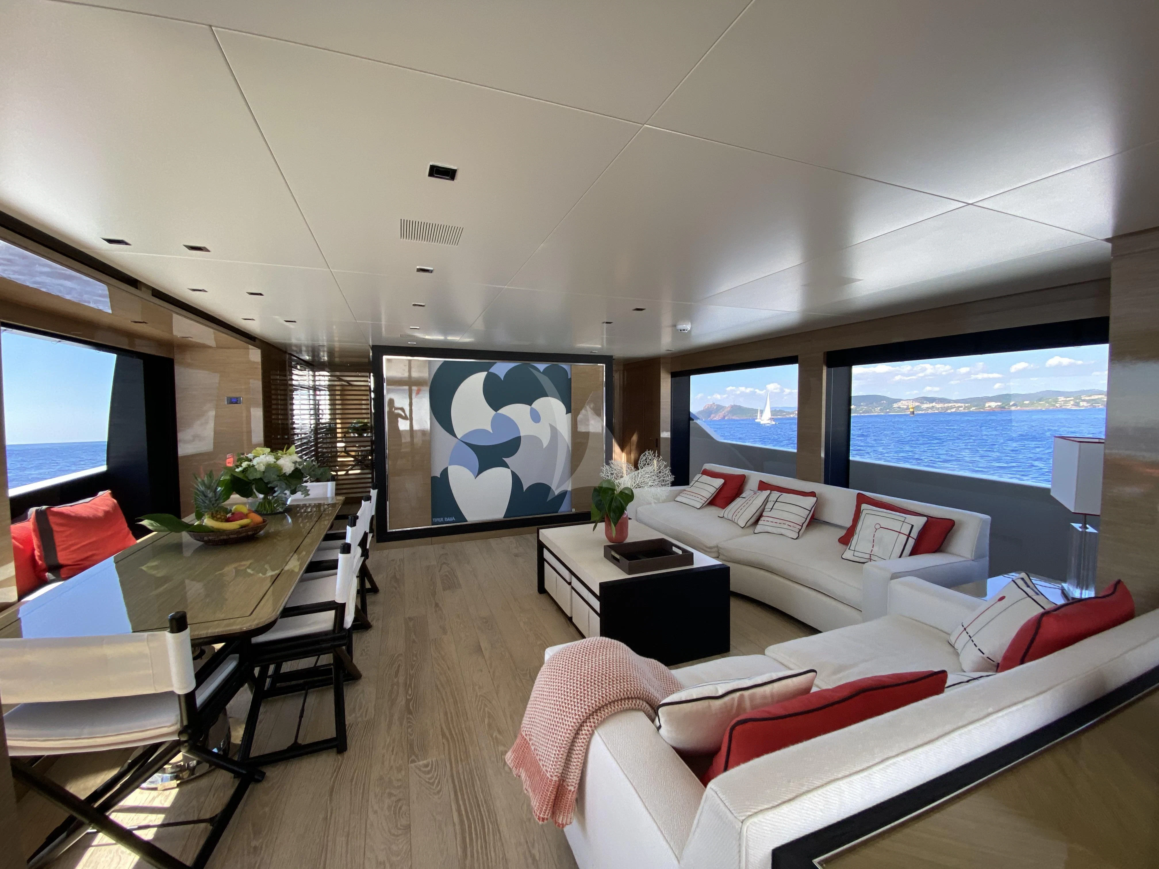 a living room with a large screen aboard REINE D'AZUR Yacht for Sale