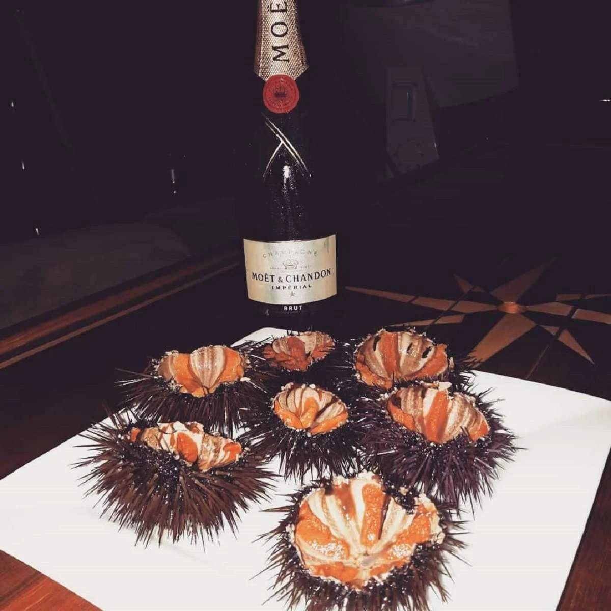 a bottle of wine and a pineapple aboard NOHEEA Yacht for Sale