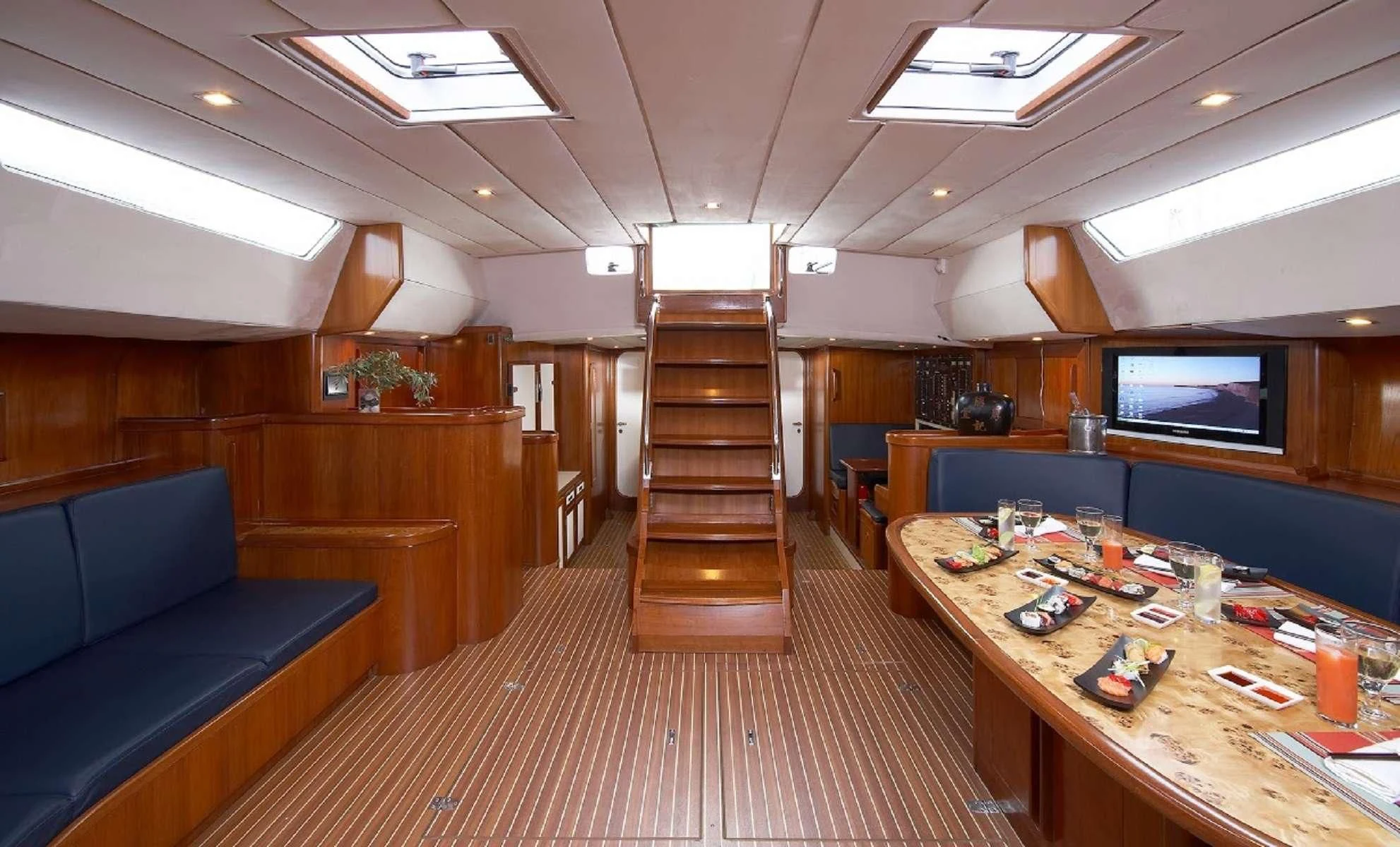 a living room with a wood staircase aboard NOHEEA Yacht for Sale