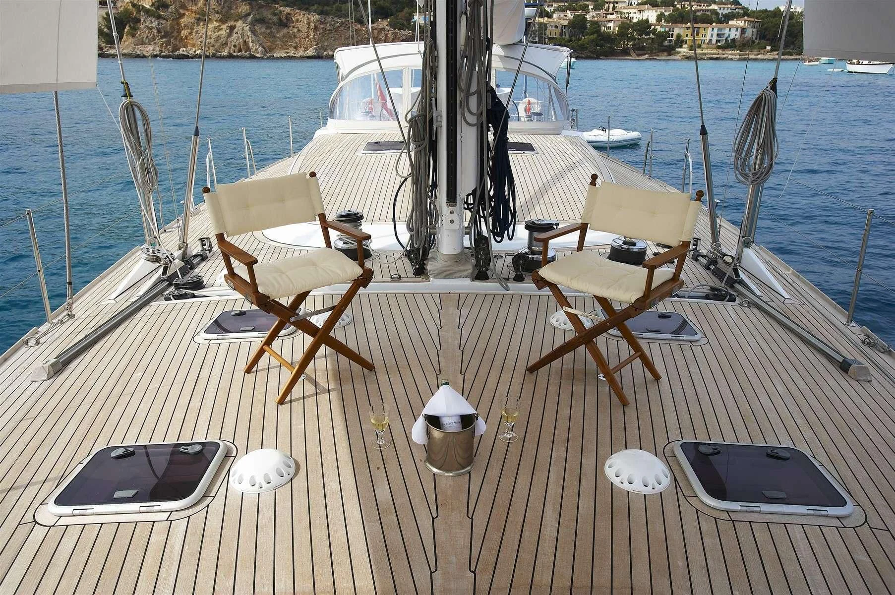 a deck with chairs and a laptop on it aboard NOHEEA Yacht for Sale