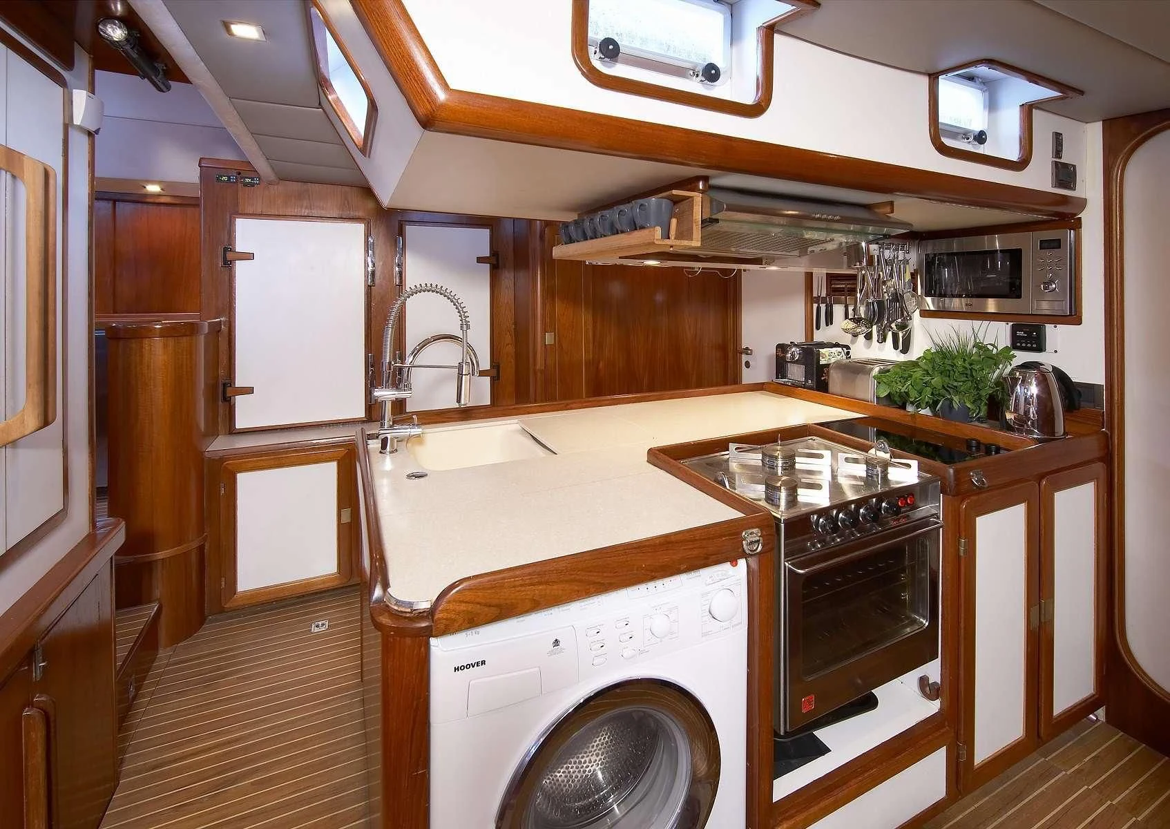 a kitchen with a washing machine aboard NOHEEA Yacht for Sale