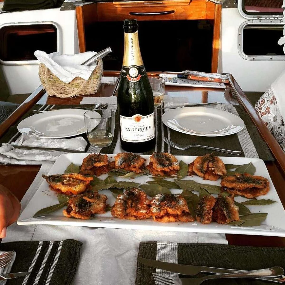 a table with food and bottles on it aboard NOHEEA Yacht for Sale