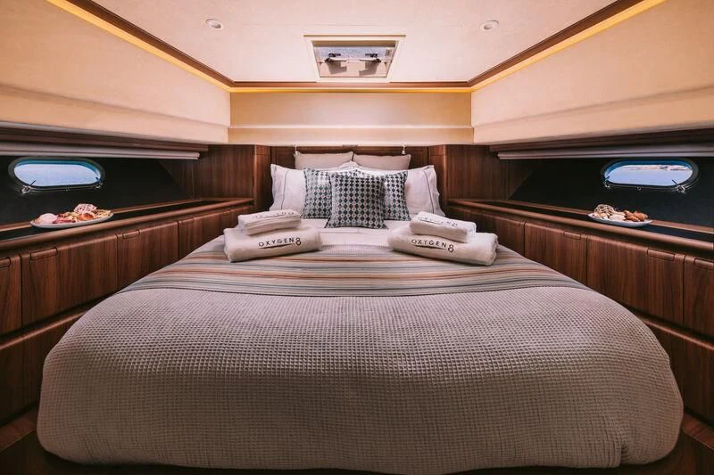 a bed with white sheets aboard OXYGEN 8 Yacht for Charter