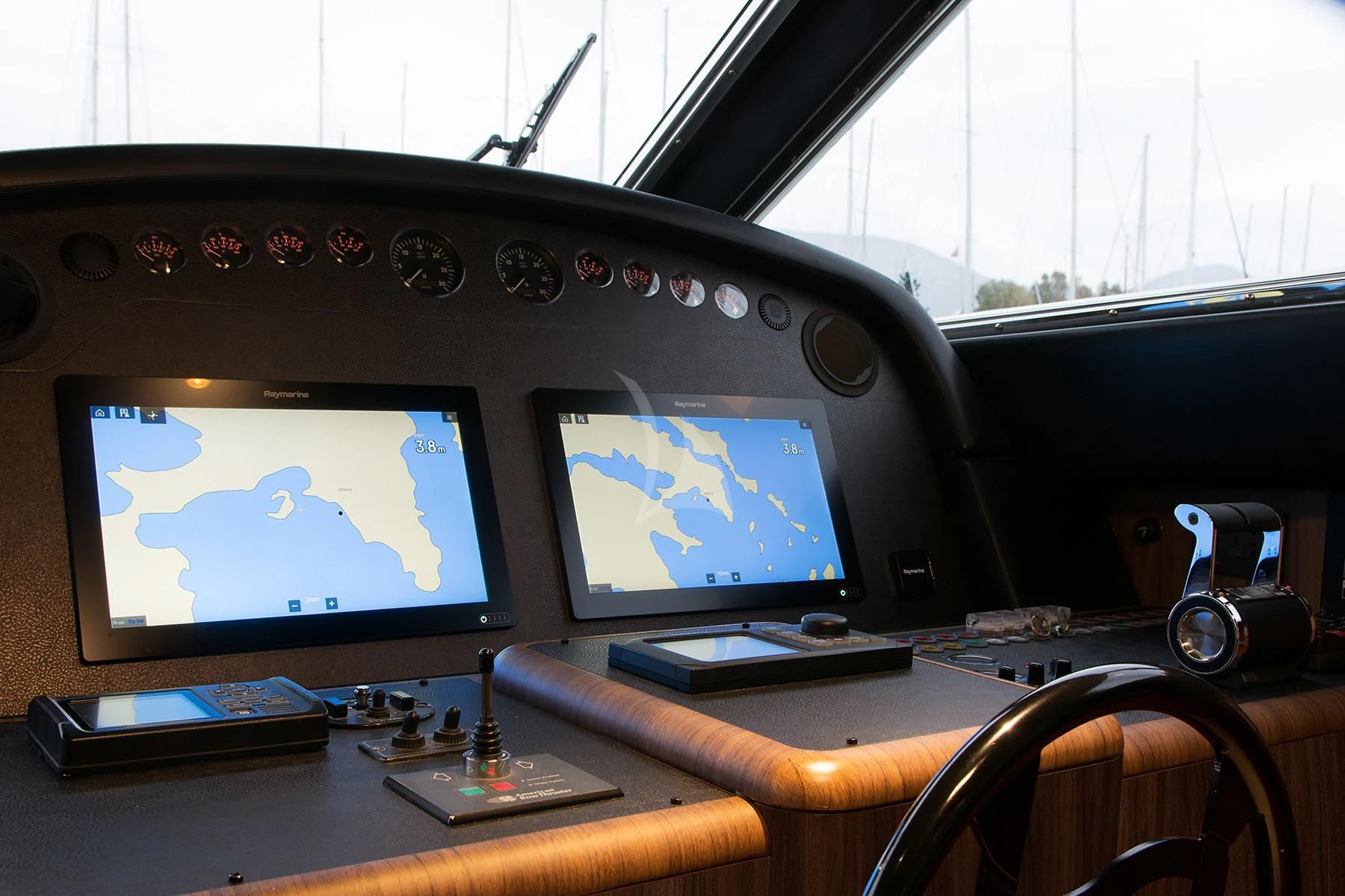 a control panel with a screen and a monitor on it aboard OXYGEN 8 Yacht for Charter