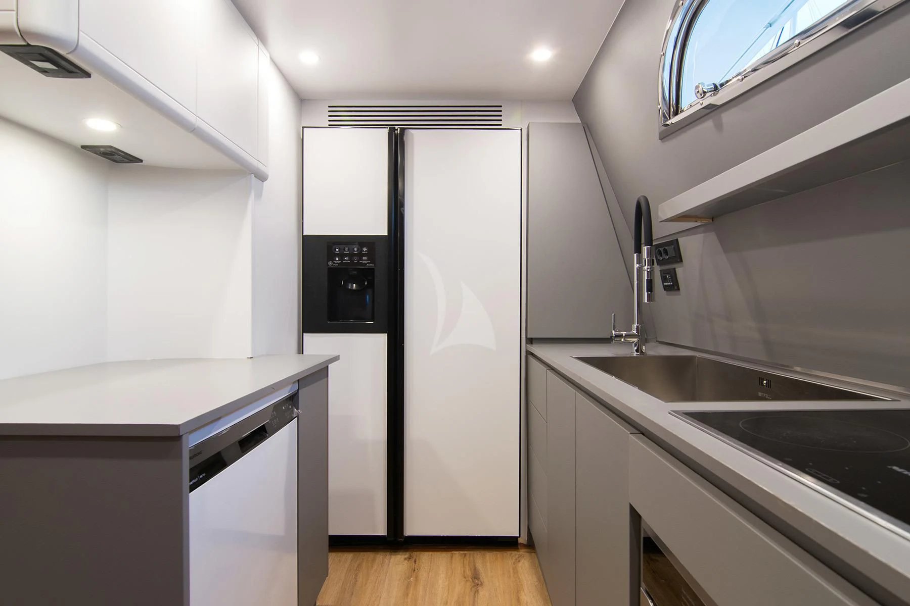a kitchen with a sink and a refrigerator aboard OXYGEN 8 Yacht for Charter