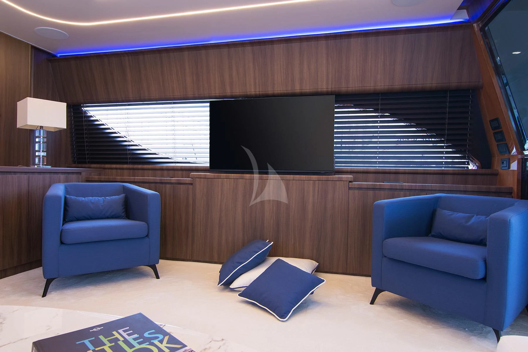 a room with a couch and a television aboard OXYGEN 8 Yacht for Charter