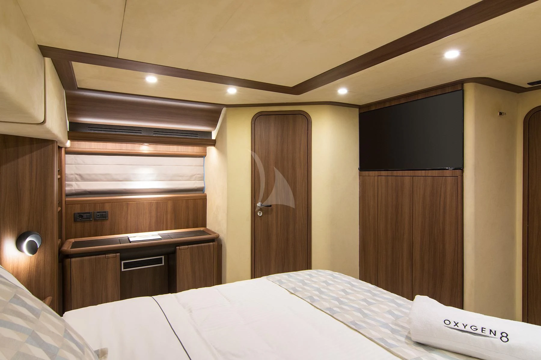a hotel room with a bed and desk aboard OXYGEN 8 Yacht for Charter