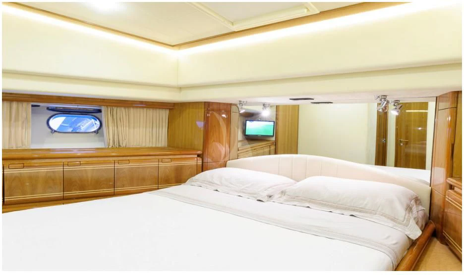 a room with a bed and a television aboard OXYGEN 8 Yacht for Charter