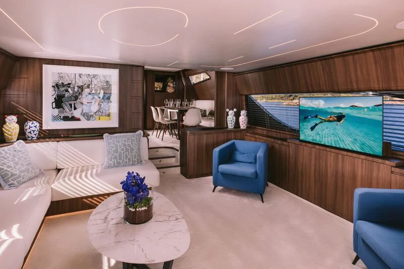 a living room with a large screen aboard OXYGEN 8 Yacht for Charter
